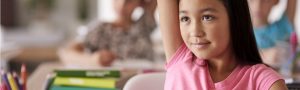 student raising hand in classroom