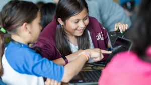 Two students looking at laptop together [Google Edu]