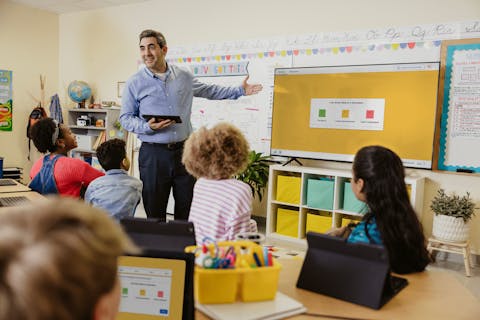 Teacher and student smiling at each other in the classroom