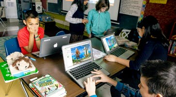 Group of students working on some laptops with their Classcraft avatar profile on the screen