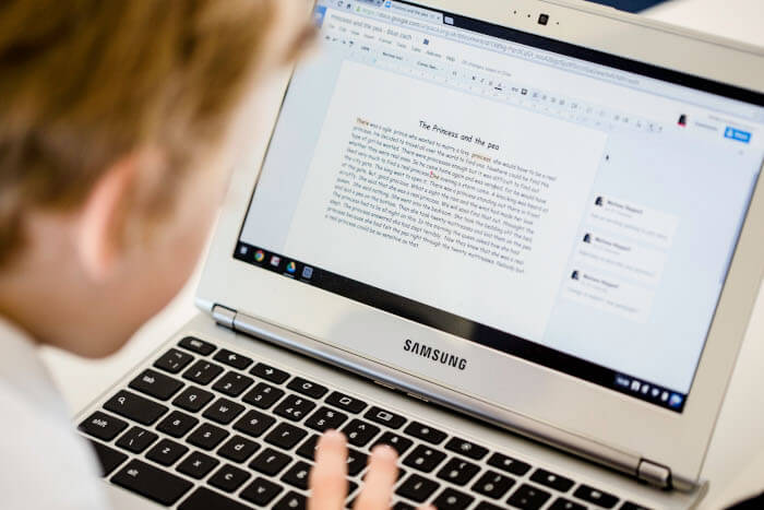 student working on his laptop with google docs open