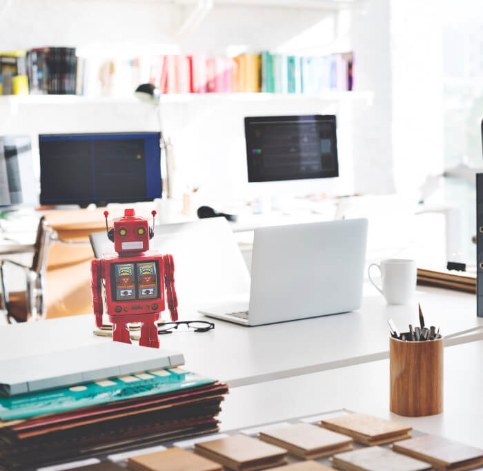 office with computers and a toy robot on the desk